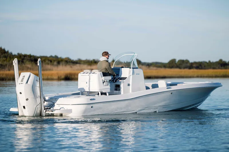 Slide: The Image of 2026 Caymas 26 HB boat on calm water. - 2