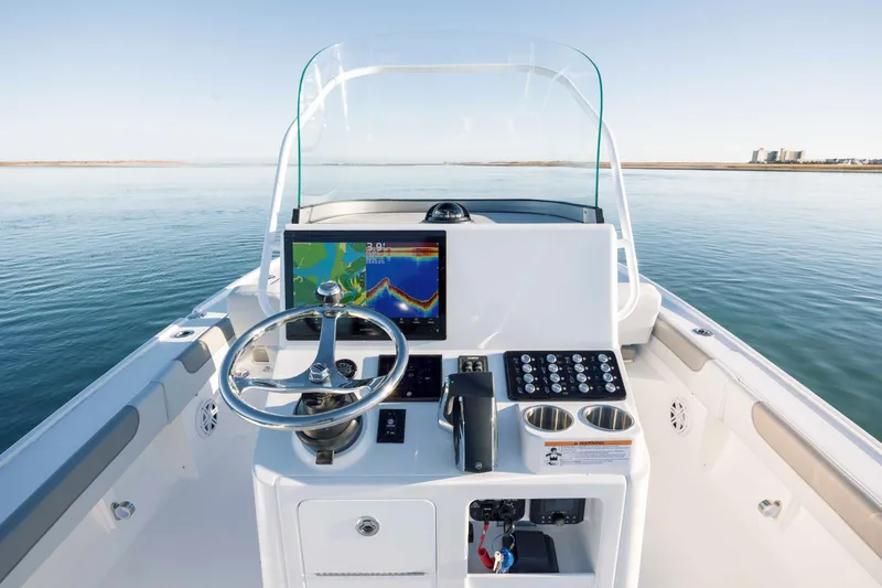 Slide: The Image of Caymas 26 HB boat helm, 2026 model, on calm waters. - 20