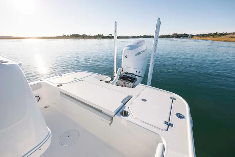 Slide: The Image of Caymas 26 HB 2026 boat on calm water at sunset. - 27