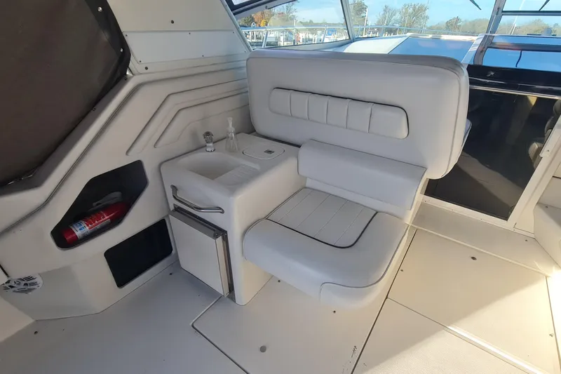 Slide: The Image of 1995 Sea Ray 400 Express Cruiser interior with white seating and compact amenities. - 11