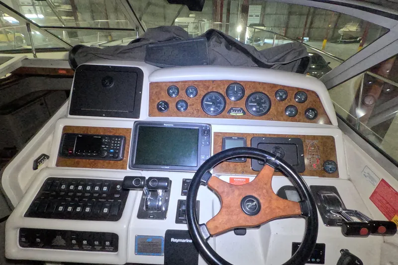 Slide: The Image of 1995 Sea Ray 400 Express Cruiser helm with gauges, controls, and navigation equipment. - 13