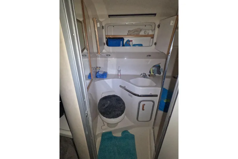 Slide: The Image of Bathroom interior of 1995 Sea Ray 400 Express Cruiser with sink and toilet. - 20