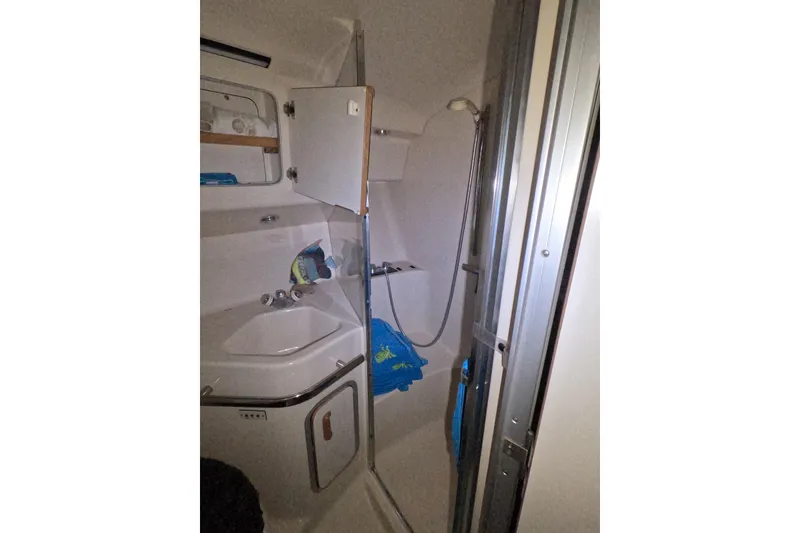 Slide: The Image of Bathroom interior of 1995 Sea Ray 400 Express Cruiser with shower and storage. - 21