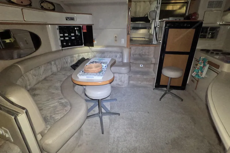 Slide: The Image of Interior of 1995 Sea Ray 400 Express Cruiser with seating and kitchenette. - 23