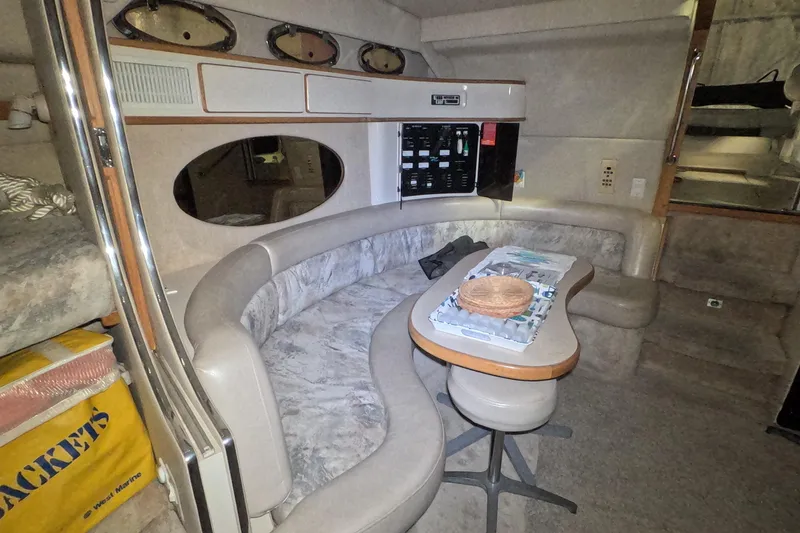 Slide: The Image of Interior of 1995 Sea Ray 400 Express Cruiser with curved seating and table. - 24