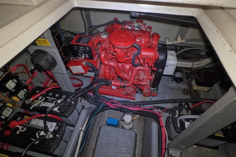 Slide: The Image of Engine compartment of a 1995 Sea Ray 400 Express Cruiser with visible wiring and components. - 26