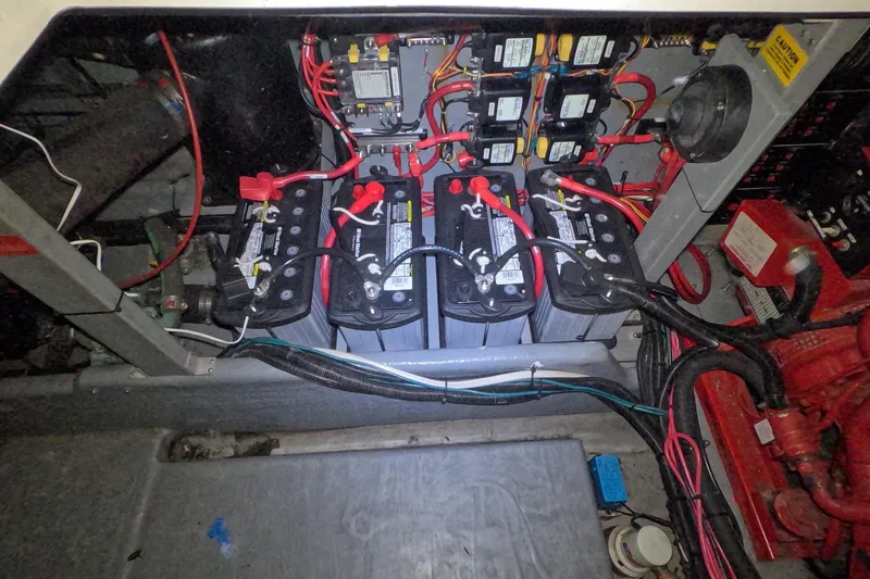 Slide: The Image of Battery compartment of a 1995 Sea Ray 400 Express Cruiser with wiring and connections. - 27