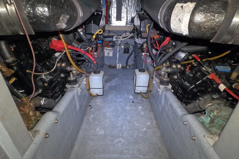 Slide: The Image of Engine room of a 1995 Sea Ray 400 Express Cruiser with visible wiring and components. - 29