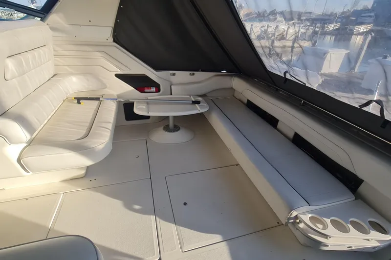 Slide: The Image of 1995 Sea Ray 400 Express Cruiser interior with white seating and table. - 3