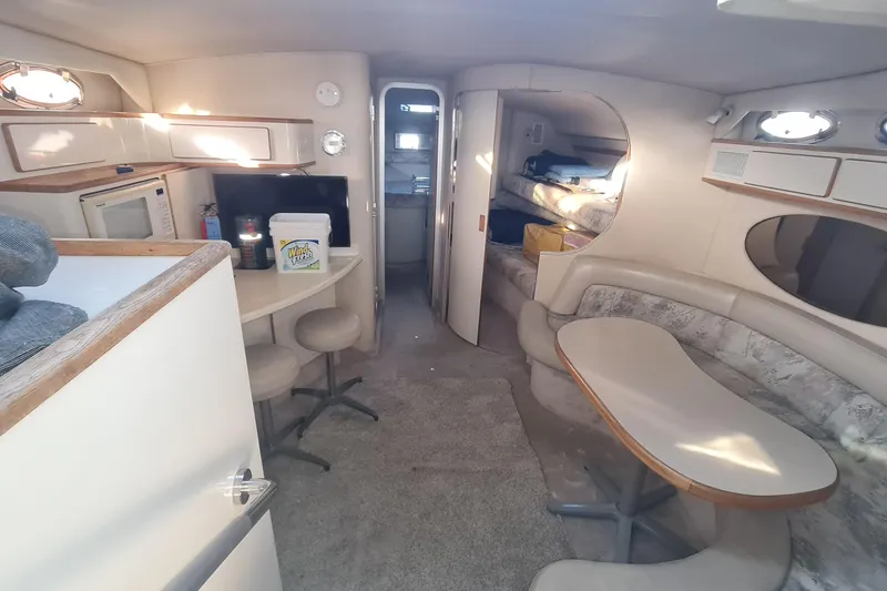 Slide: The Image of Interior of a 1995 Sea Ray 400 Express Cruiser with seating and kitchenette. - 7