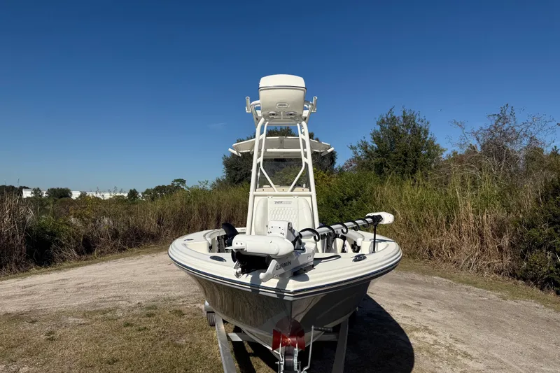 Slide: The Image of 2025 Pathfinder 2400 Open boat on trailer, surrounded by greenery under clear blue sky. - 11