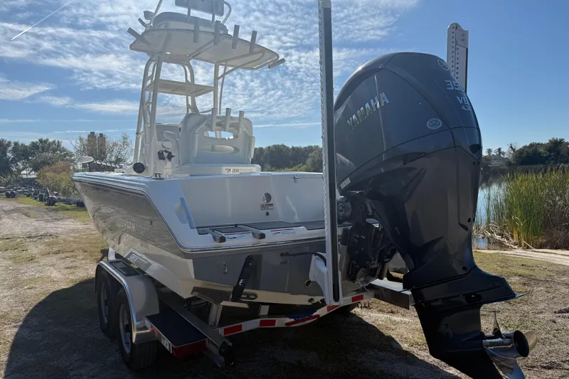 Slide: The Image of 2025 Pathfinder 2400 Open boat with Yamaha engine on trailer, parked near a lake. - 3
