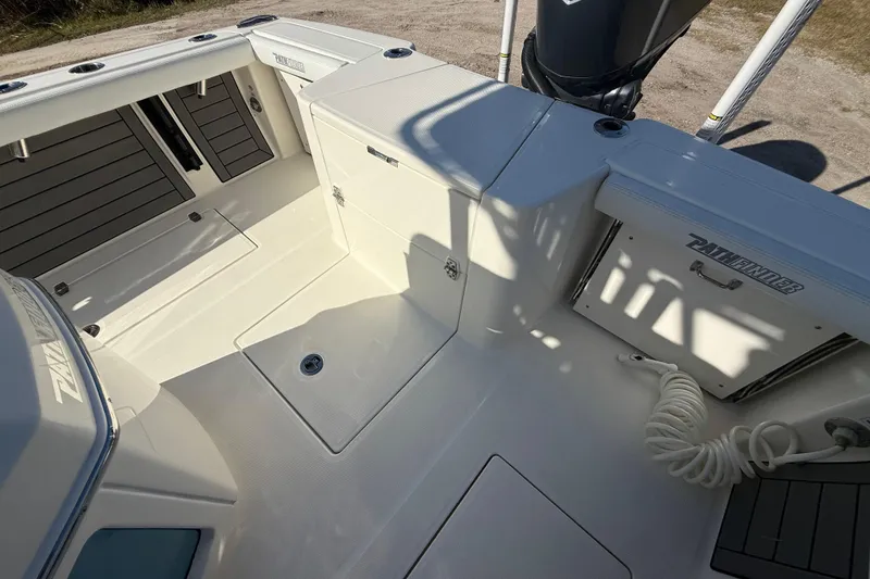 Slide: The Image of 2025 Pathfinder 2400 Open boat interior with storage compartments and clean deck design. - 31