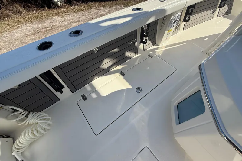 Slide: The Image of 2025 Pathfinder 2400 Open boat deck with storage compartments and coiled rope. - 33