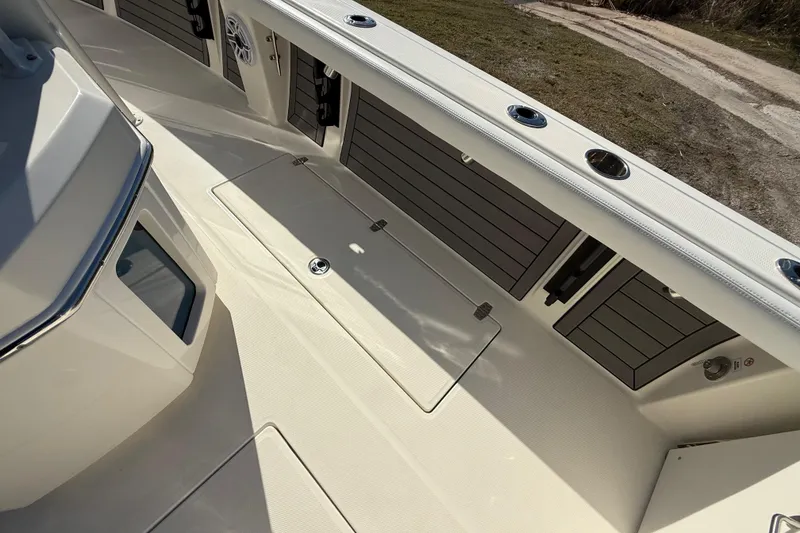 Slide: The Image of 2025 Pathfinder 2400 Open boat interior with storage compartments and sleek design. - 36