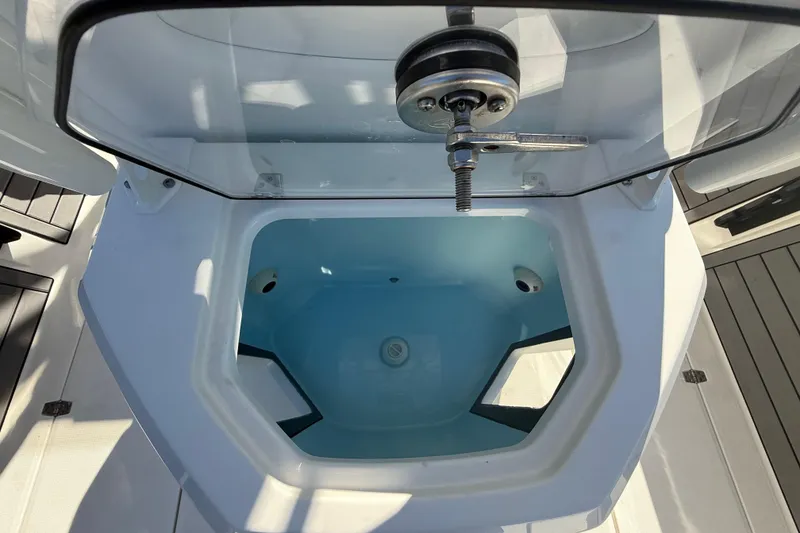 Slide: The Image of Livewell compartment on 2025 Pathfinder 2400 Open boat, featuring a clear lid and secure latch. - 38