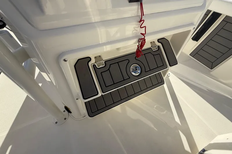 Slide: The Image of 2025 Pathfinder 2400 Open boat interior with storage compartment and safety lanyard. - 43