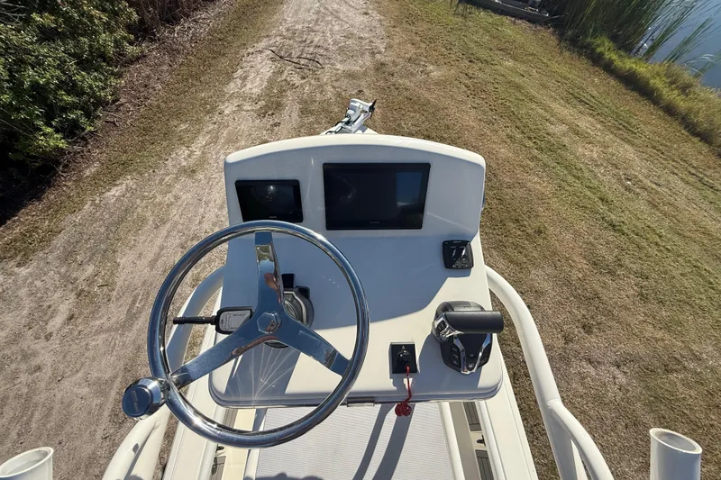 Slide: The Image of Steering console of 2025 Pathfinder 2400 Open boat on a grassy path. - 54