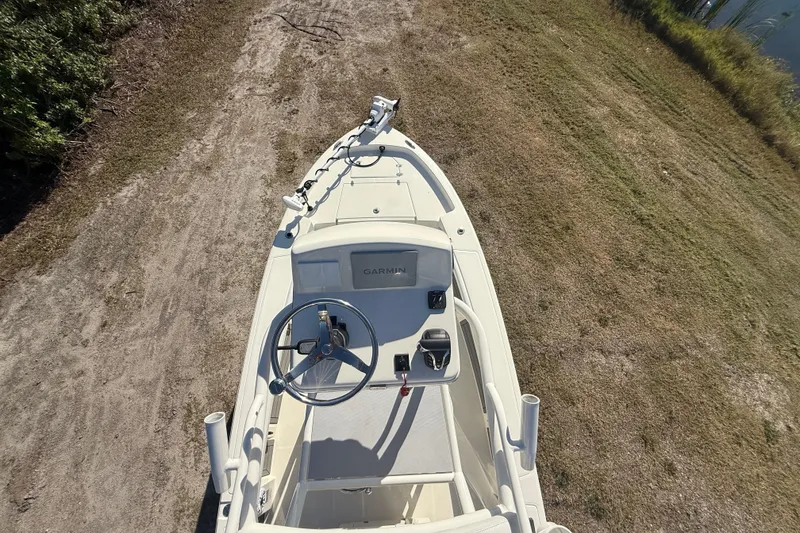 Slide: The Image of 2025 Pathfinder 2400 Open boat on grassy terrain, top view of helm and controls. - 56