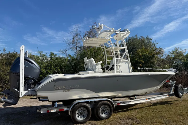 Slide: The Image of 2025 Pathfinder 2400 Open boat on trailer, side view under clear blue sky. - 7
