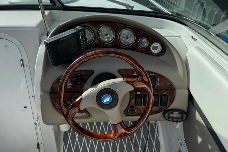 Slide: The Image of Dashboard of 2004 Four Winns 205 Sundowner boat with woodgrain steering wheel and gauges. - 17