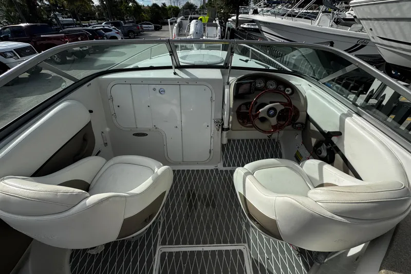 Slide: The Image of 2004 Four Winns 205 Sundowner boat interior with white seating and dashboard controls. - 6