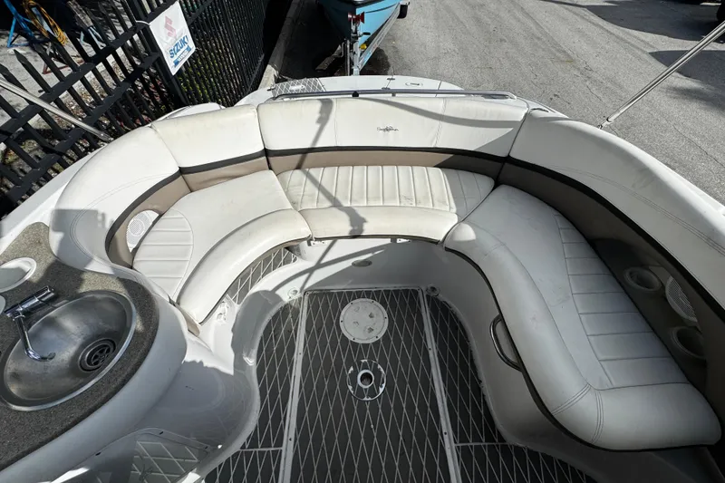 Slide: The Image of 2004 Four Winns 205 Sundowner boat interior with white seating and built-in sink. - 7