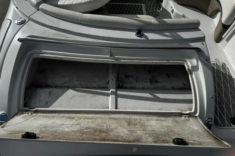 Slide: The Image of Open storage compartment on a 2004 Four Winns 205 Sundowner boat. - 9