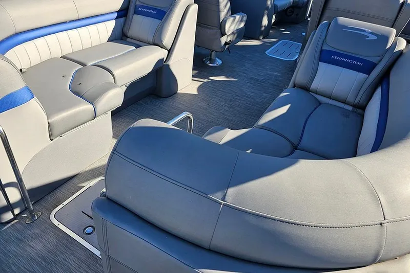 Slide: The Image of 2022 Bennington 24 LXFB boat interior with gray and blue seating. - 13