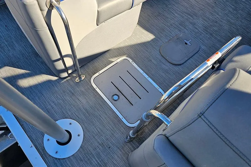 Slide: The Image of 2022 Bennington 24 LXFB boat interior with gray flooring and seating. - 14