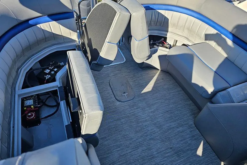 Slide: The Image of 2022 Bennington 24 LXFB boat interior with spacious seating and storage compartments. - 16