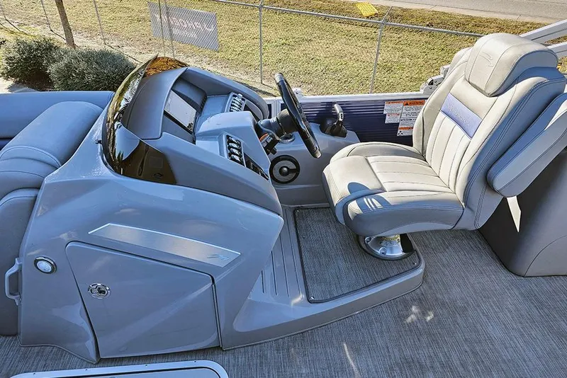 Slide: The Image of 2022 Bennington 24 LXFB boat interior with sleek helm and comfortable captain's chair. - 18