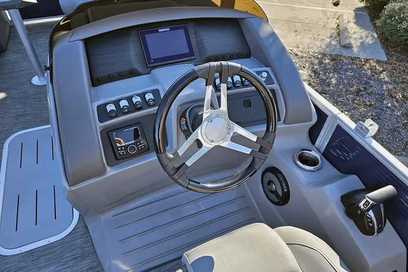 Slide: The Image of Steering console of 2022 Bennington 24 LXFB pontoon boat with modern controls and display. - 19