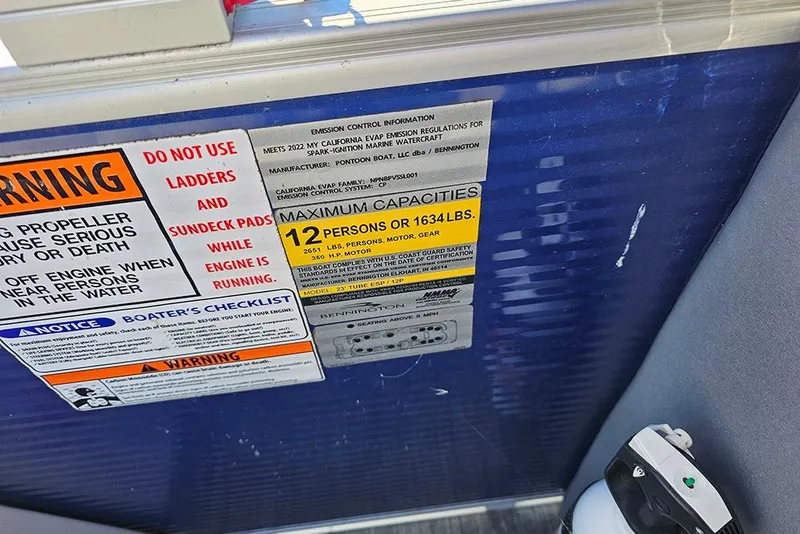 Slide: The Image of Warning and capacity labels on a 2022 Bennington 24 LXFB boat. - 20