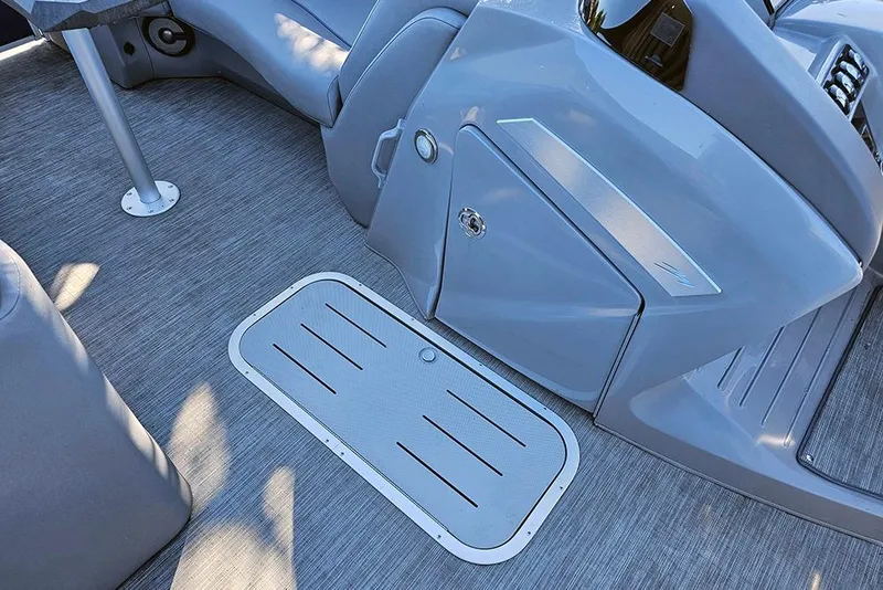Slide: The Image of Interior of 2022 Bennington 24 LXFB boat, featuring sleek gray flooring and seating. - 21