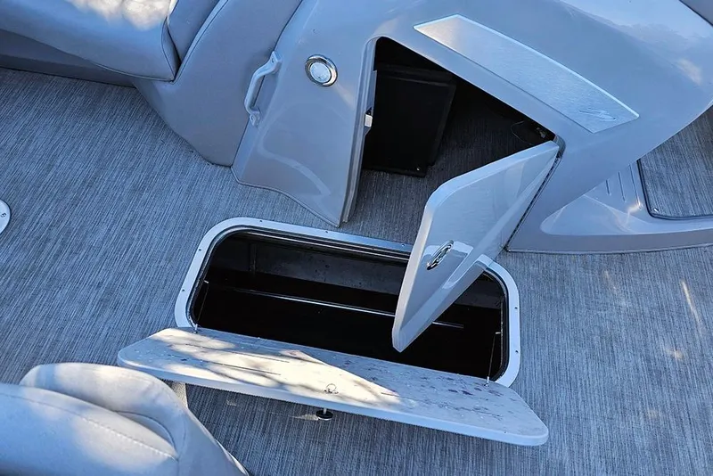 Slide: The Image of 2022 Bennington 24 LXFB boat storage compartments open on deck. - 22