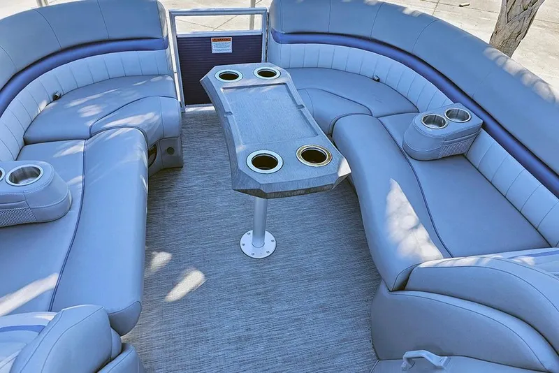 Slide: The Image of 2022 Bennington 24 LXFB boat interior with plush seating and cup holders. - 24