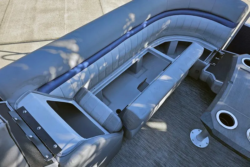 Slide: The Image of 2022 Bennington 24 LXFB boat interior with open storage compartments and seating. - 25