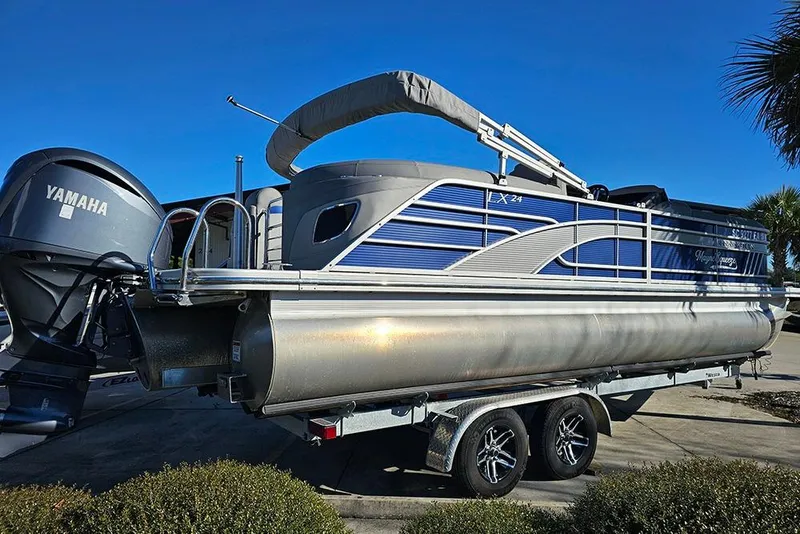 Slide: The Image of 2022 Bennington 24 LXFB pontoon boat with Yamaha engine on trailer. - 7