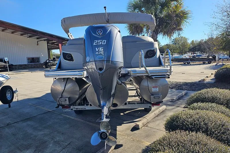 Slide: The Image of 2022 Bennington 24 LXFB pontoon boat with Yamaha V6 250 engine, parked outdoors. - 8