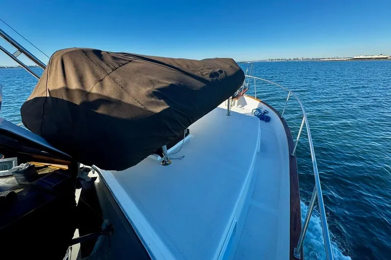 Slide: The Image of 1979 Californian 34 boat cruising on open water under clear blue sky. - 14