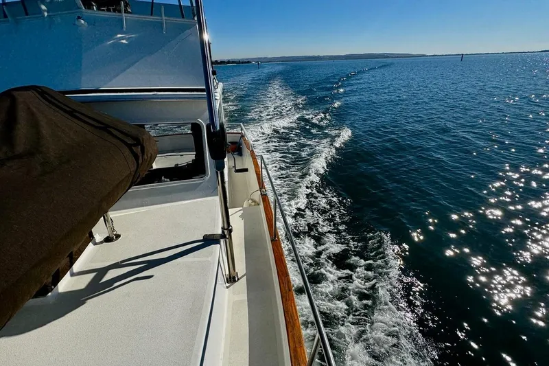 Slide: The Image of 1979 Californian 34 yacht cruising on sunny, sparkling blue waters. - 16