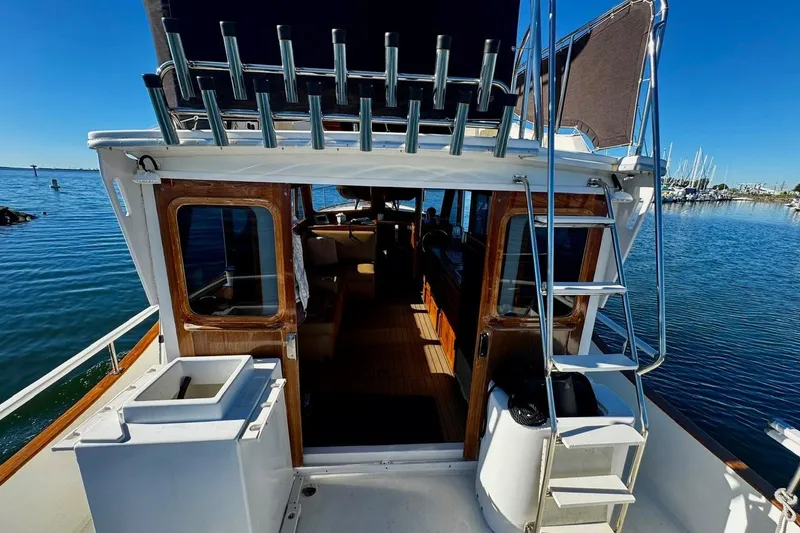 Slide: The Image of 1979 Californian 34 yacht with open cabin, docked on a sunny day. - 17