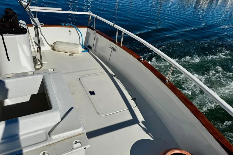 Slide: The Image of 1979 Californian 34 boat deck with railing, cruising on calm blue water. - 18