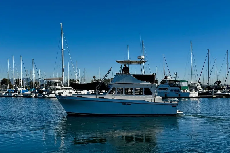 Slide: The Image of 1979 Californian 34 boat cruising in a marina with sailboats in the background. - 2