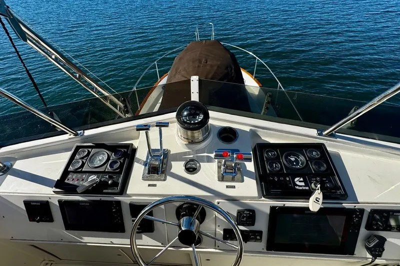 Slide: The Image of Helm of 1979 Californian 34 boat with navigational instruments and steering wheel on open water. - 23