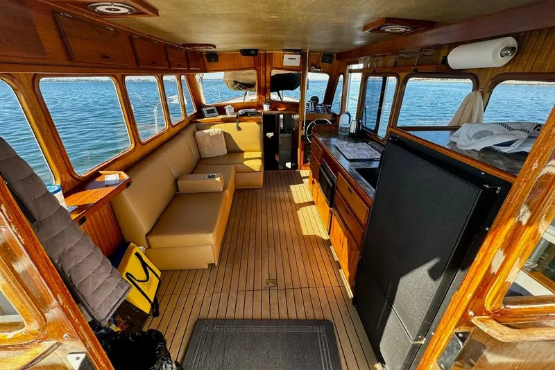 Slide: The Image of Interior of a 1979 Californian 34 boat with wood paneling and seating. - 24