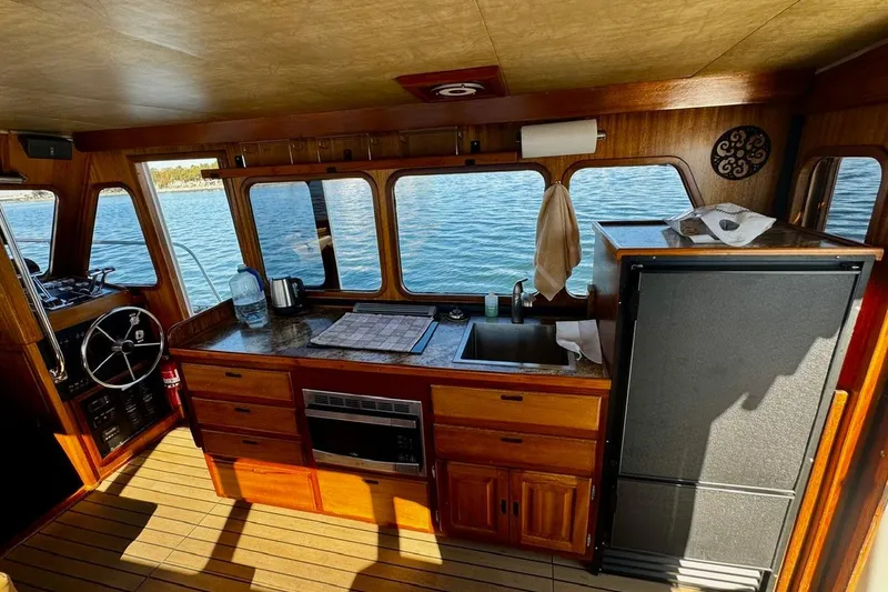 Slide: The Image of Interior of a 1979 Californian 34 boat with wooden cabinetry and ocean view. - 25