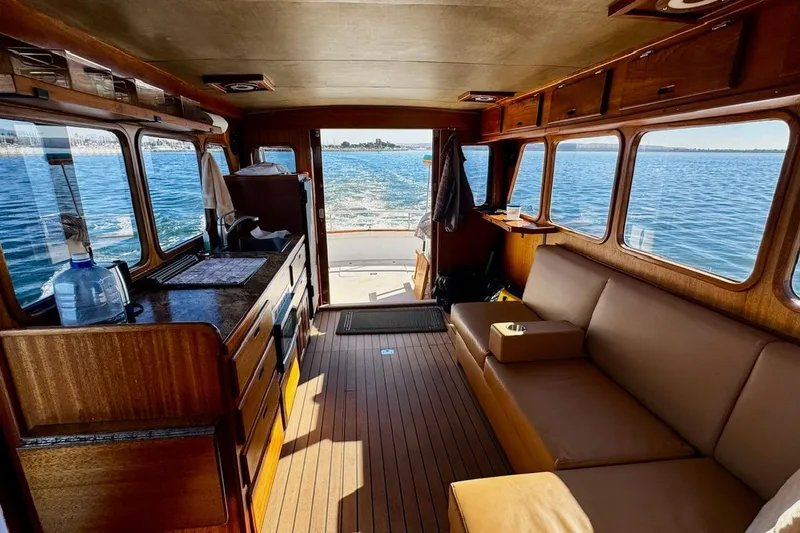 Slide: The Image of Interior of a 1979 Californian 34 boat with wooden furnishings and ocean view. - 27