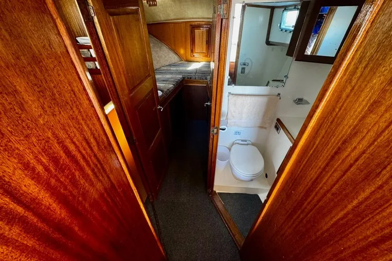 Slide: The Image of Interior of 1979 Californian 34 boat with wooden finish and compact bathroom. - 30